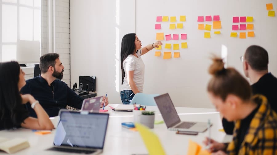A team around a table comparing performance management modules and pricing