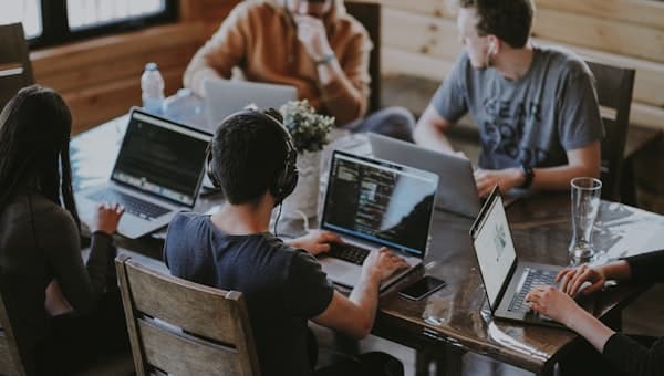 A team working around a laptop